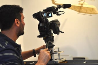 A cameraman films Brian Doan's artworks. 