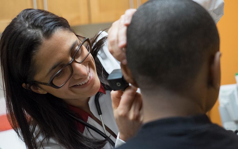 Dr Mona Hanna-Attisha examining a patient.