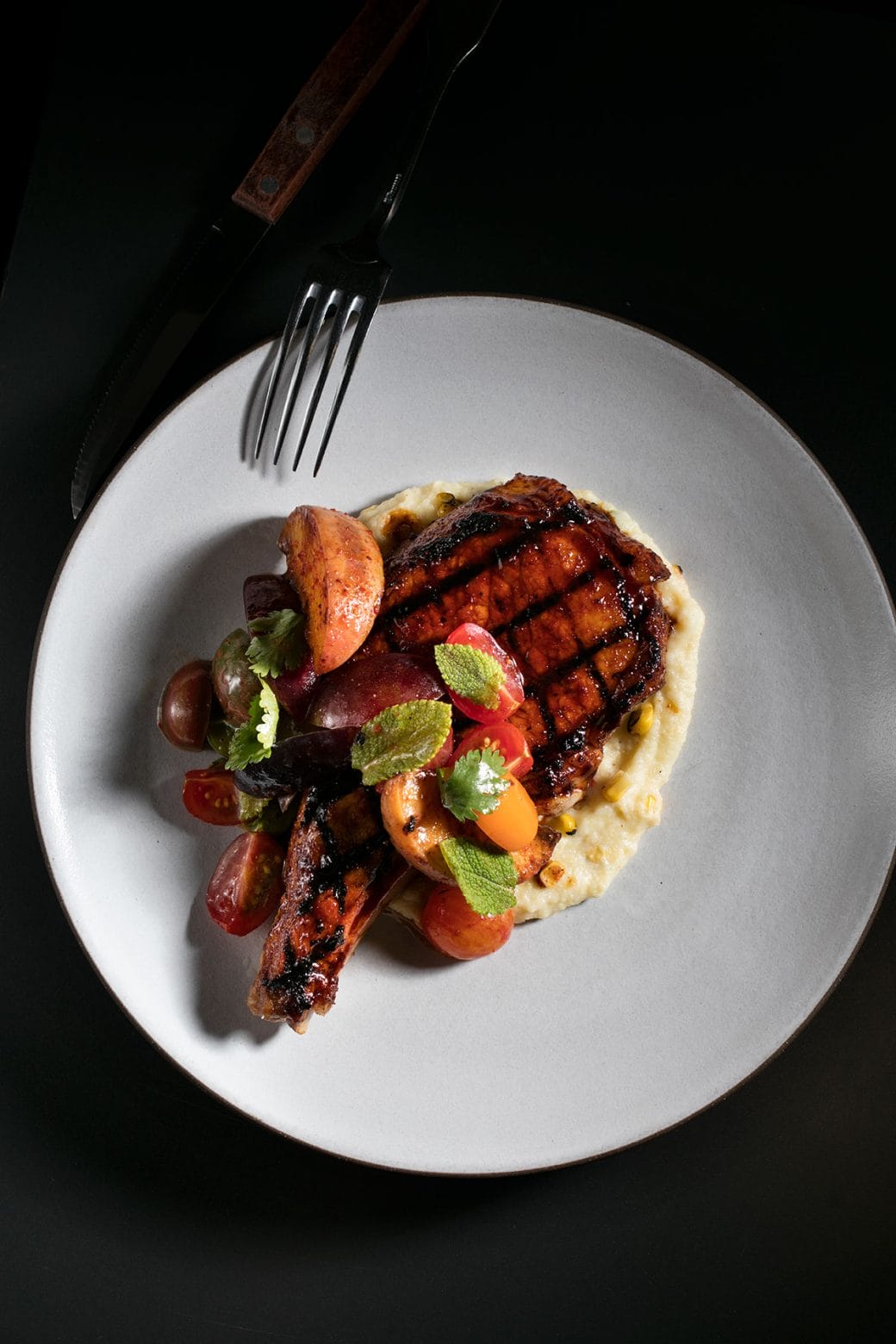 Soy-and Sugarcane-Glazed Grilled Pork Chops with Tomato Peach Salad