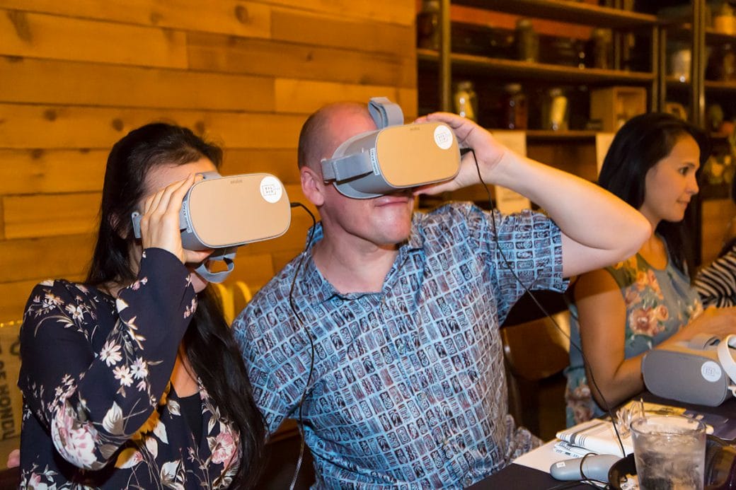 Rick Kinsel dons a virtual reality headset for Jenny Dorsey’s presentation of Asian in America. Photo courtesy of Rae Huo.