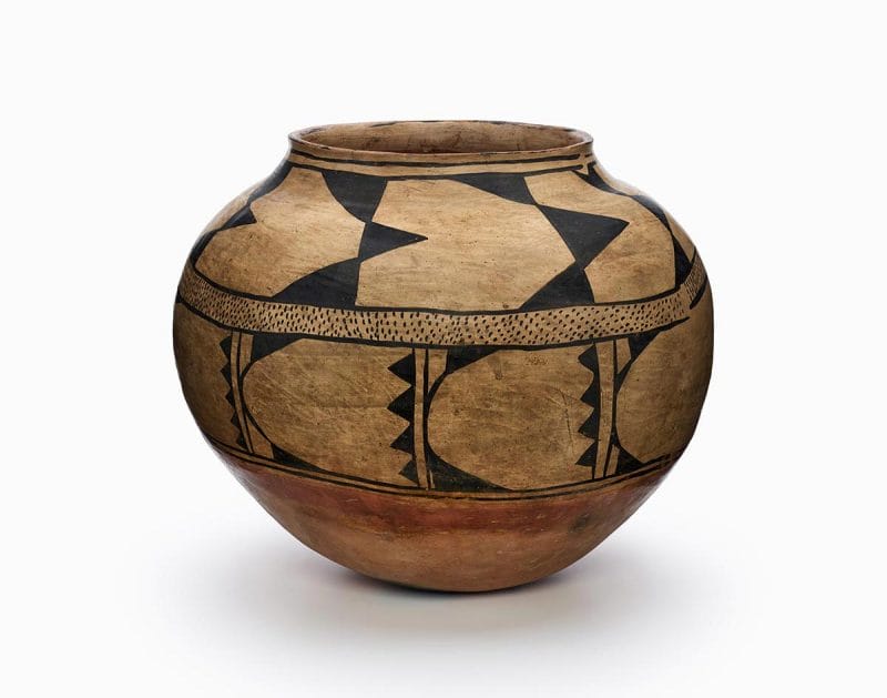 A Kewa storage jar with black and red painted decoration.