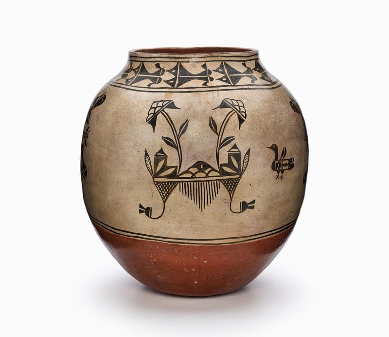 A Cochiti olla with floral designs, waterbird pictorials, and a rust bottom.