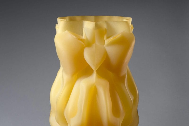 Translucent yellow abstract sculpture with multiple folds.