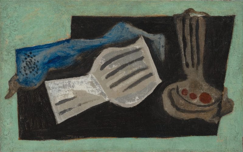 Still life featuring a flattened vase, open book, and blue fabric on a black and green background.