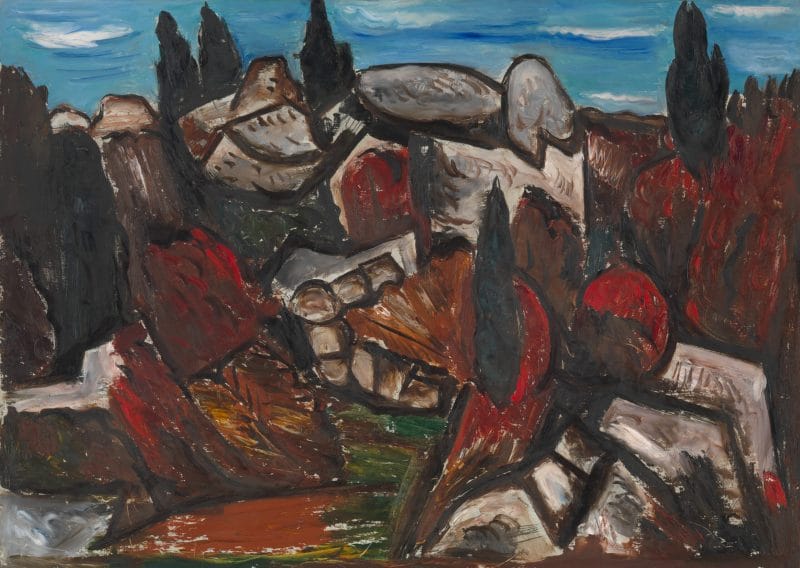Hill of rugged rocks interplaced with a red and green thicket against a blue sky.