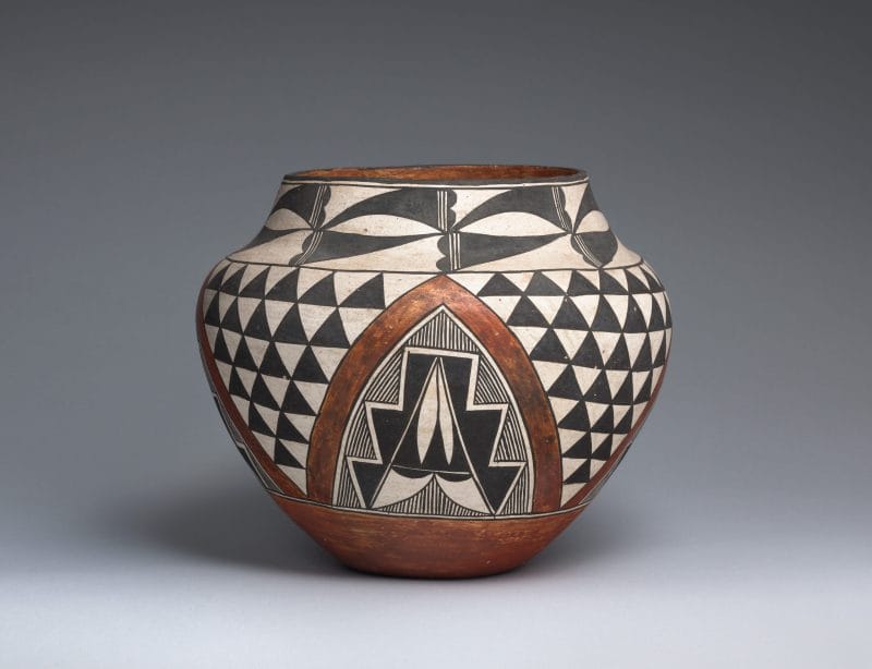 Brown Acoma jar designed with black and white geometric patterns and a centered arch.