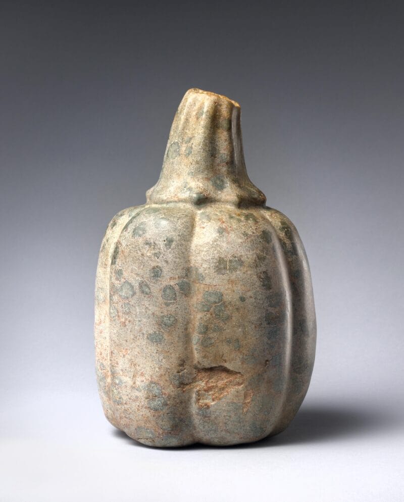 Realistic stone sculpture of a whole squash or gourd.