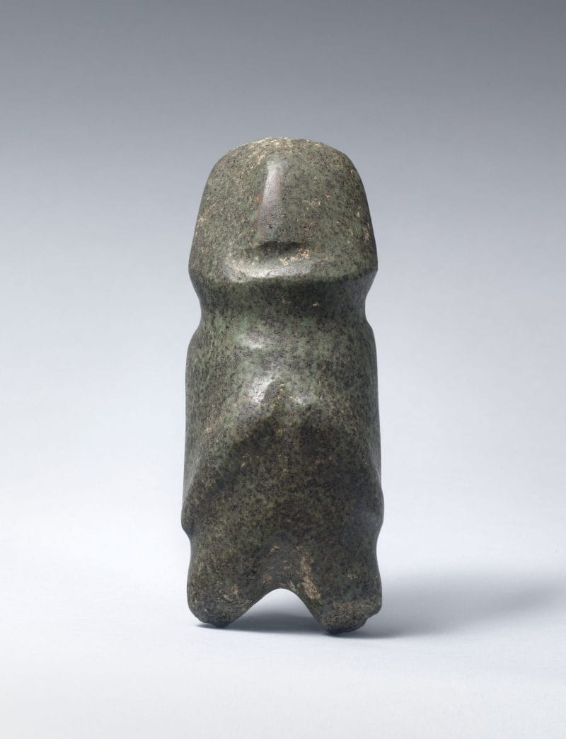 An abstract rounded stone figure molded to represent a human.
