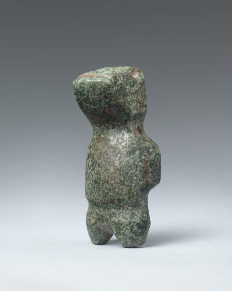 Abstract stone standing figure with human and animal characteristics.
