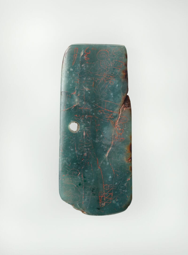 Jade green plaque with incised images of Mayan dignitary figures.