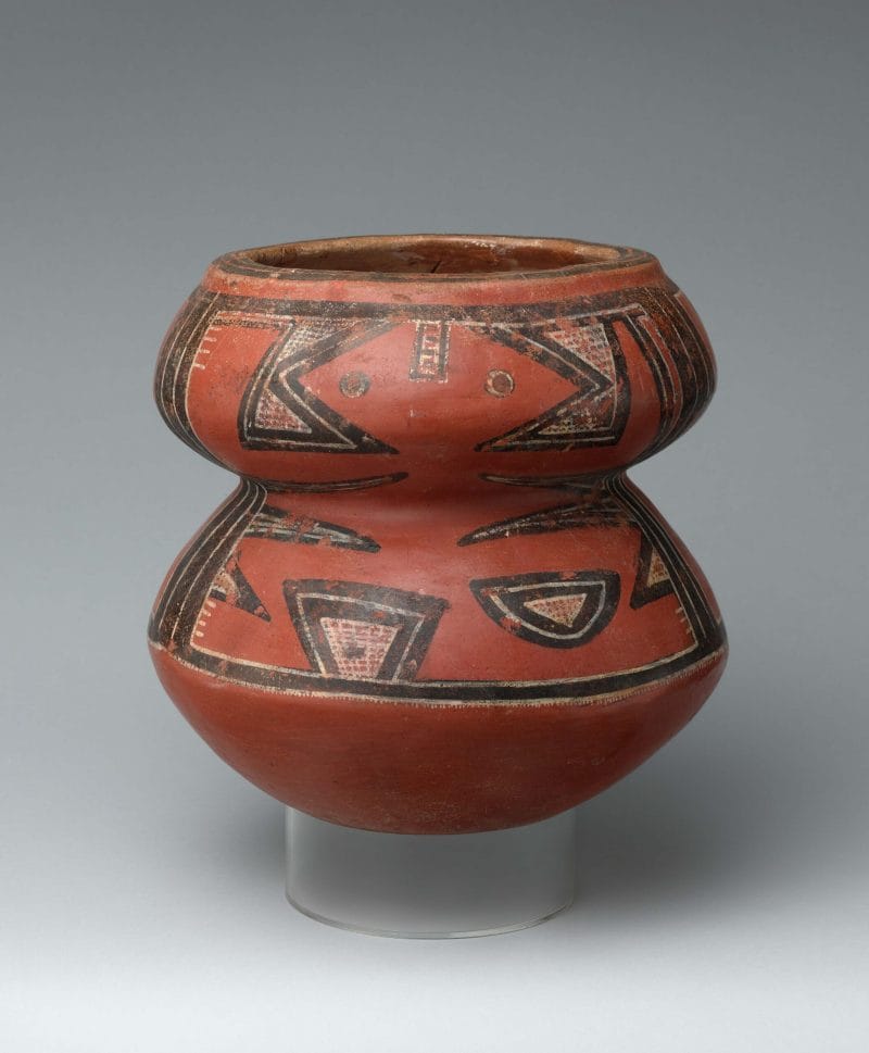 A jar painted in vibrant polychrome representing a human and/or animal.