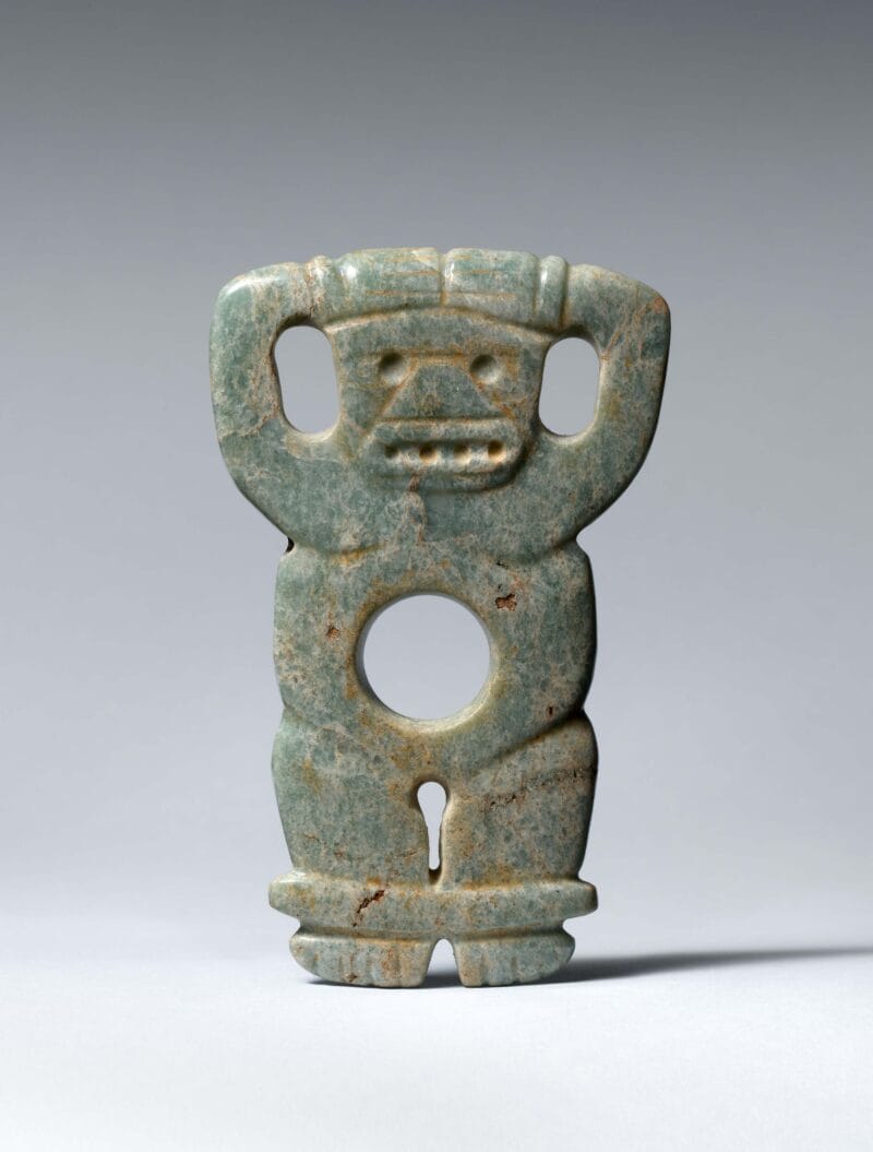 Pendant of a figure with both hands on their head and a large round hole in the chest.