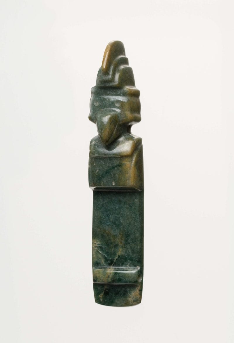A dark green and yellow jade celt featuring a Costa Rican bird wearing three-tiered crown.