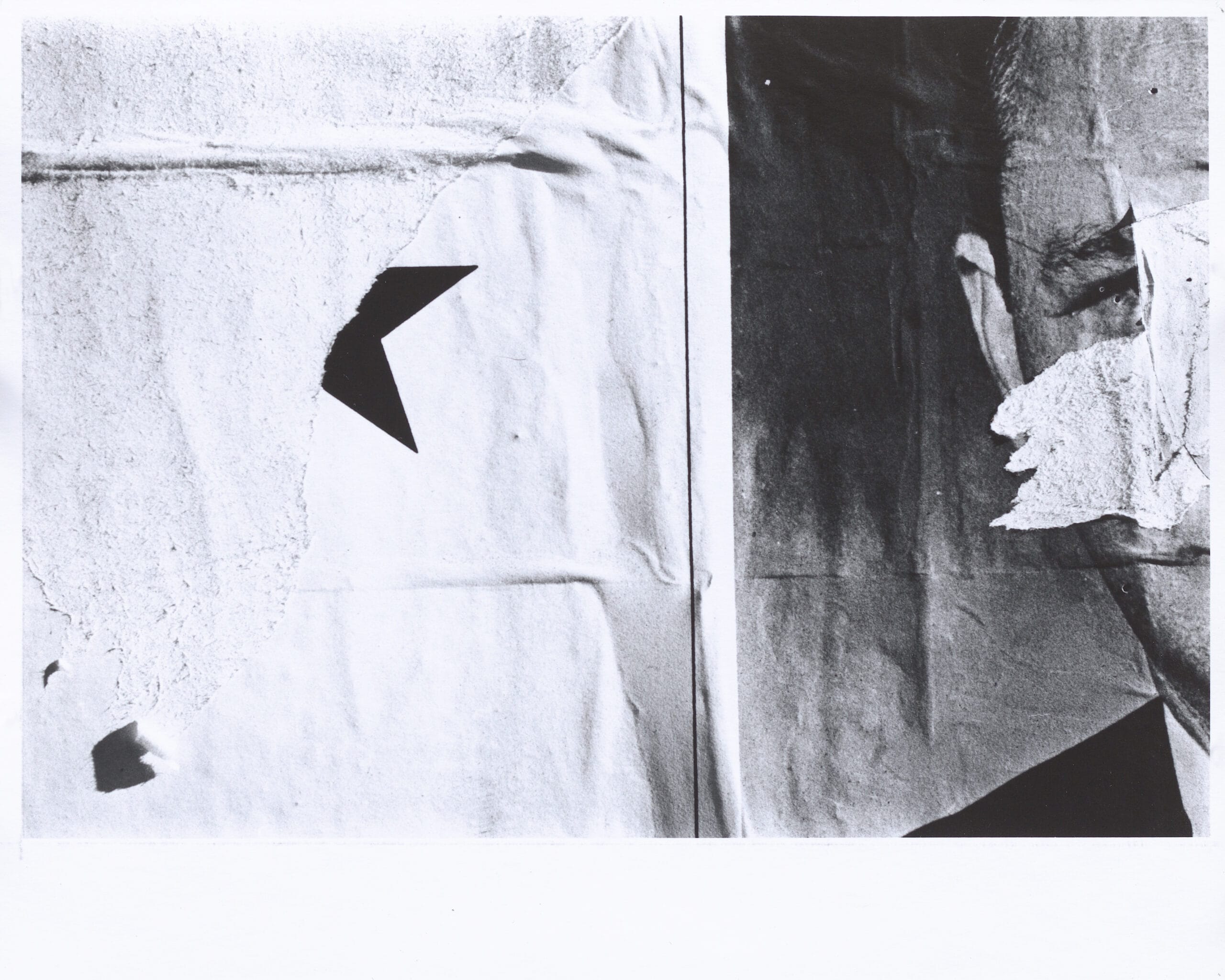 Black and white photograph of layered torn signs featuring portions of a star and a man's face separated by a vertical line.