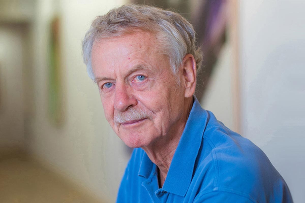 A photo of Rudolf Jaenisch wearing a blue polo shirt.