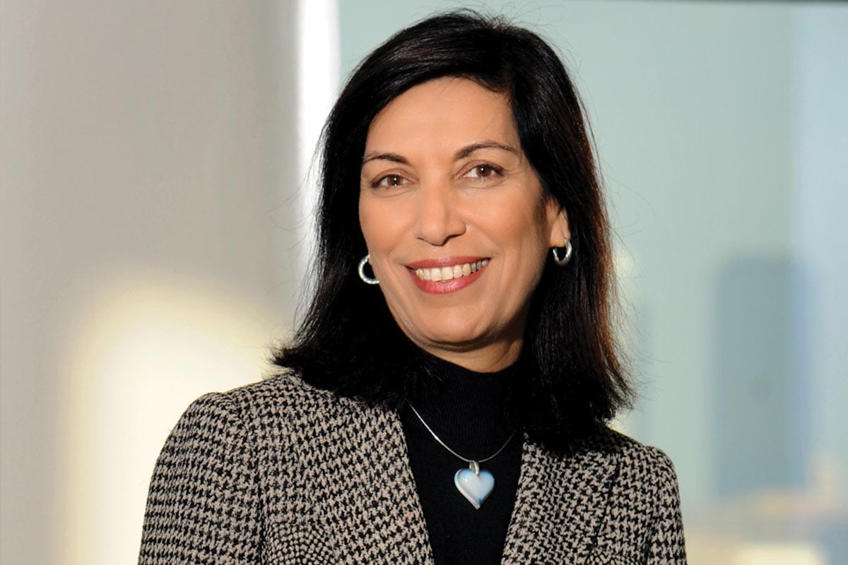 A photo of Huda Zoghbi in a neutral coat.