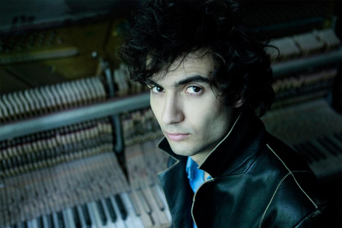 A photo of Tigran Hamasyan at a piano.