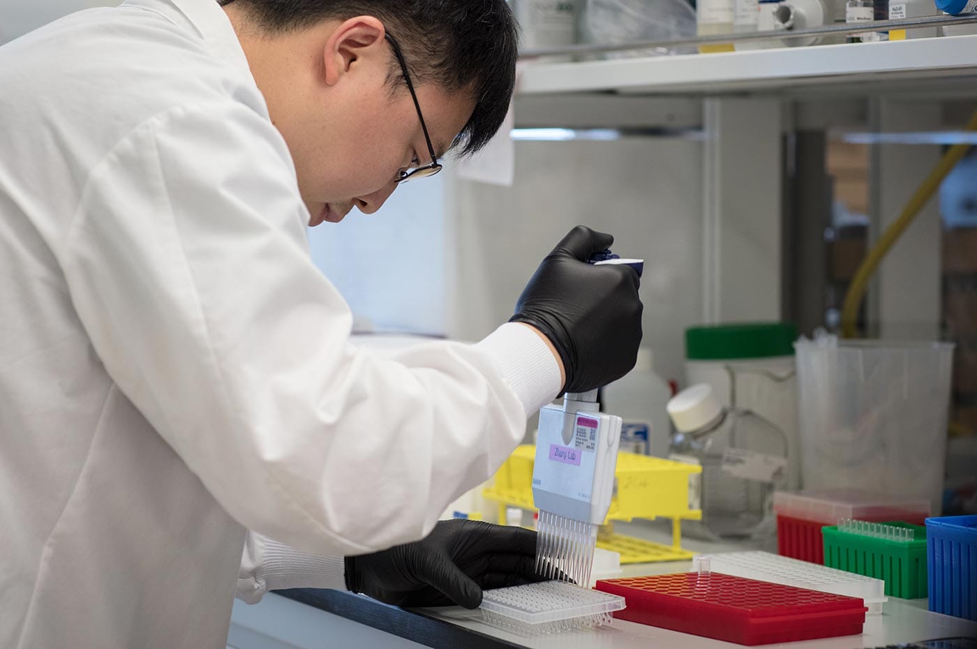 Feng Zhang at a bench in his lab