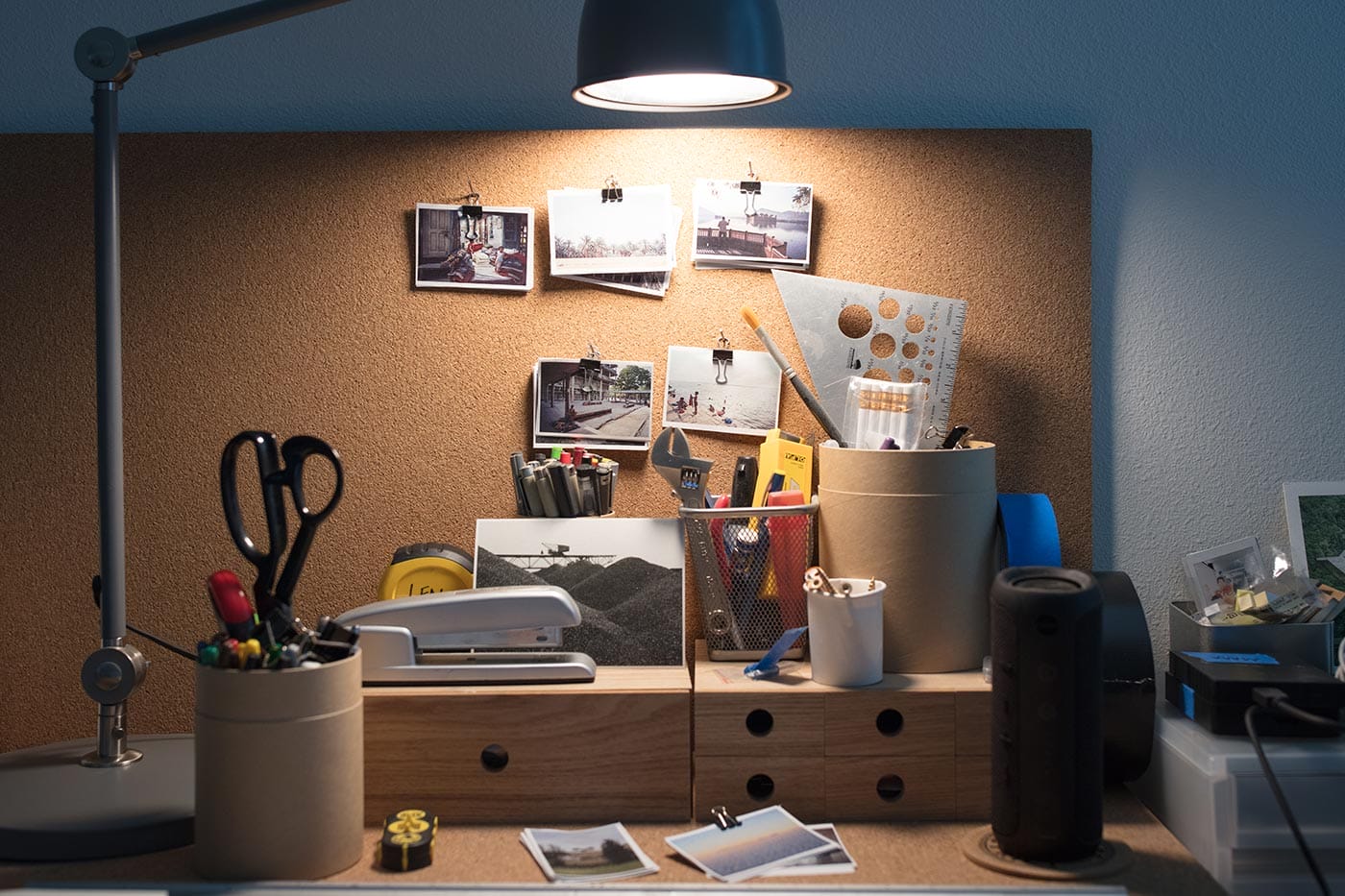Architectural photos and tools on James Leng's desk.