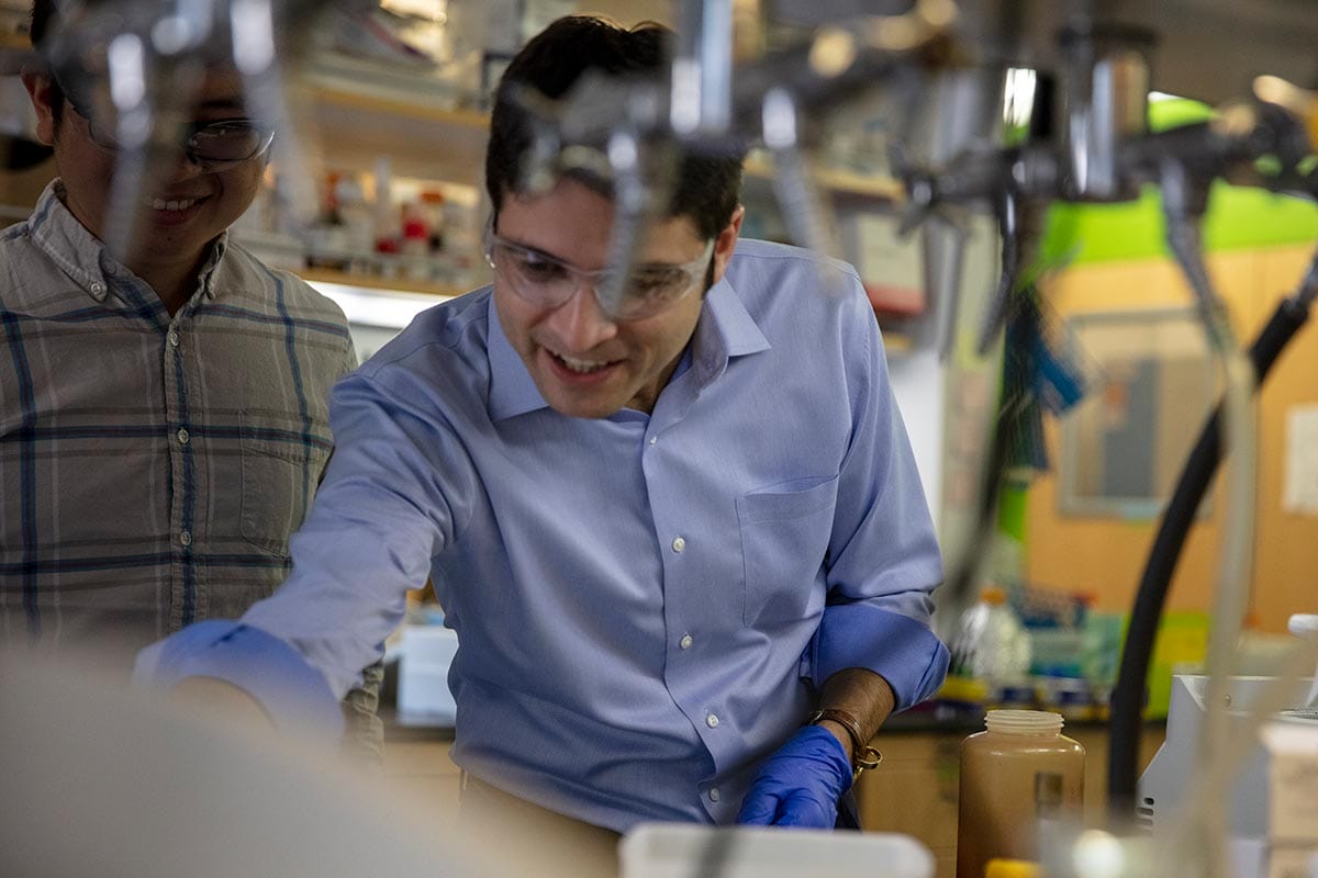 A photo of Mikhail G. Shapiro with students in his lab