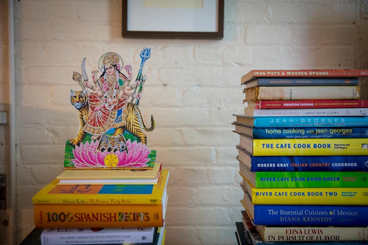 Tejal Rao's culinary books and personal effects on a shelf.