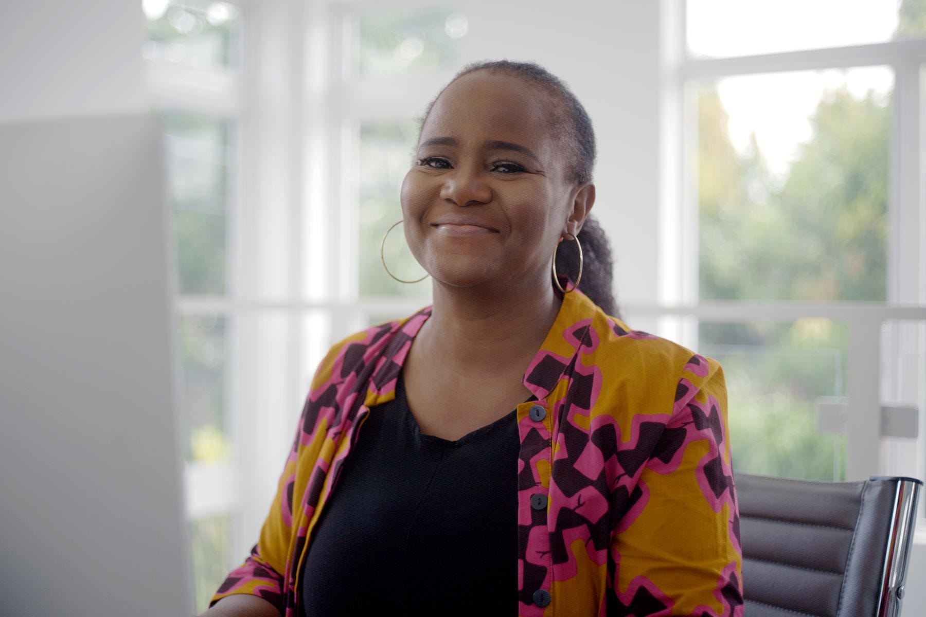 Author Edwidge Danticat sitting at a computer in her office.