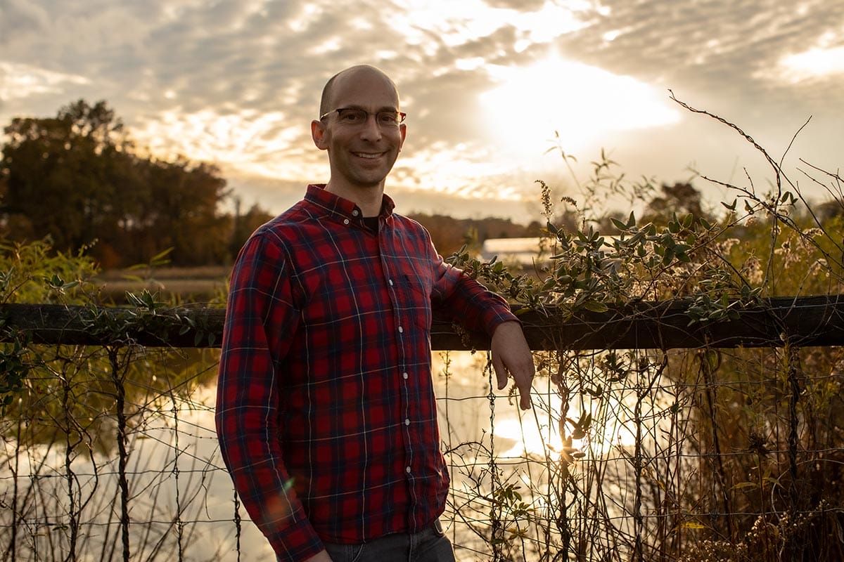 Standing in front of a lake on a farm in New Jersey, Martin Jonikas is working toward environment-friendly food production and helping to combat climate change.