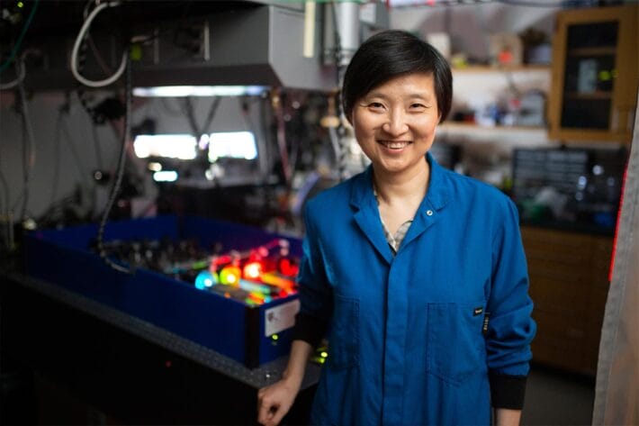 Vilcek Prizewinner Xiaowei Zhuang in front of a STORM microscope at Harvard University.