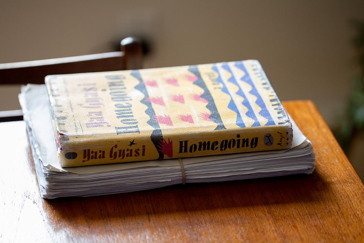 Author Yaa Gyasi's novel "Homegoing" sitting atop the original manuscript.