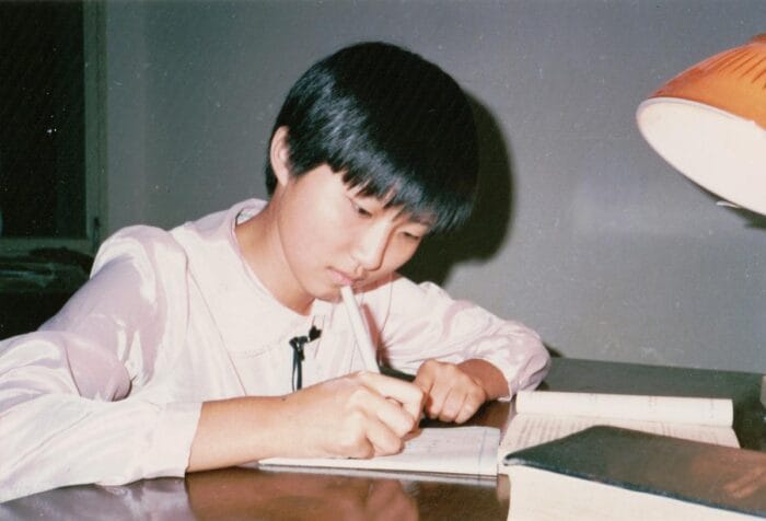 Xiaowei Zhuang studying in college.