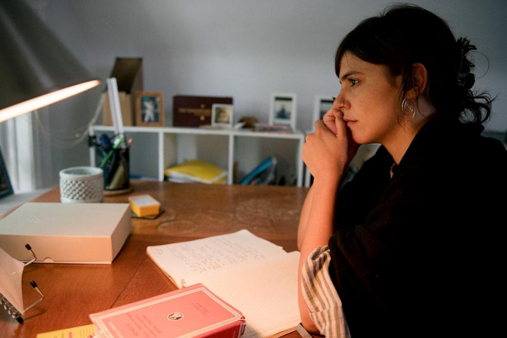 Valeria Luiselli writing at a desk.