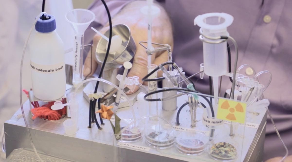 A close-up of laboratory testing equipment including multiple tubes, petri dishes, and syringes.