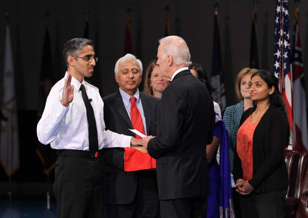 Vivek Murthy, with hand on bible and other hand raised, is sworn in as Surgeon General of the United States.