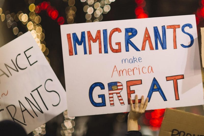 Protestors gather, holding signs that read Immigrants Make America Great, to support DACA.