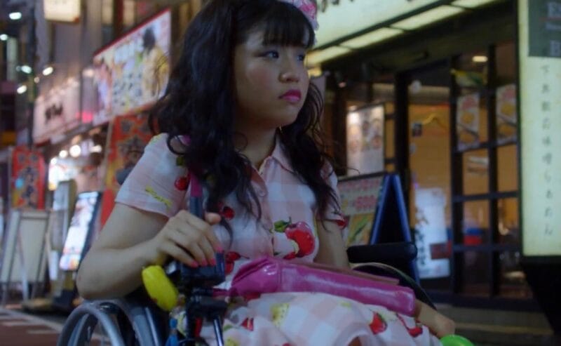 The protagonist in '37 Seconds', Yuma, is pictured in her wheelchair, making her way down a busy commercial street in Japan.