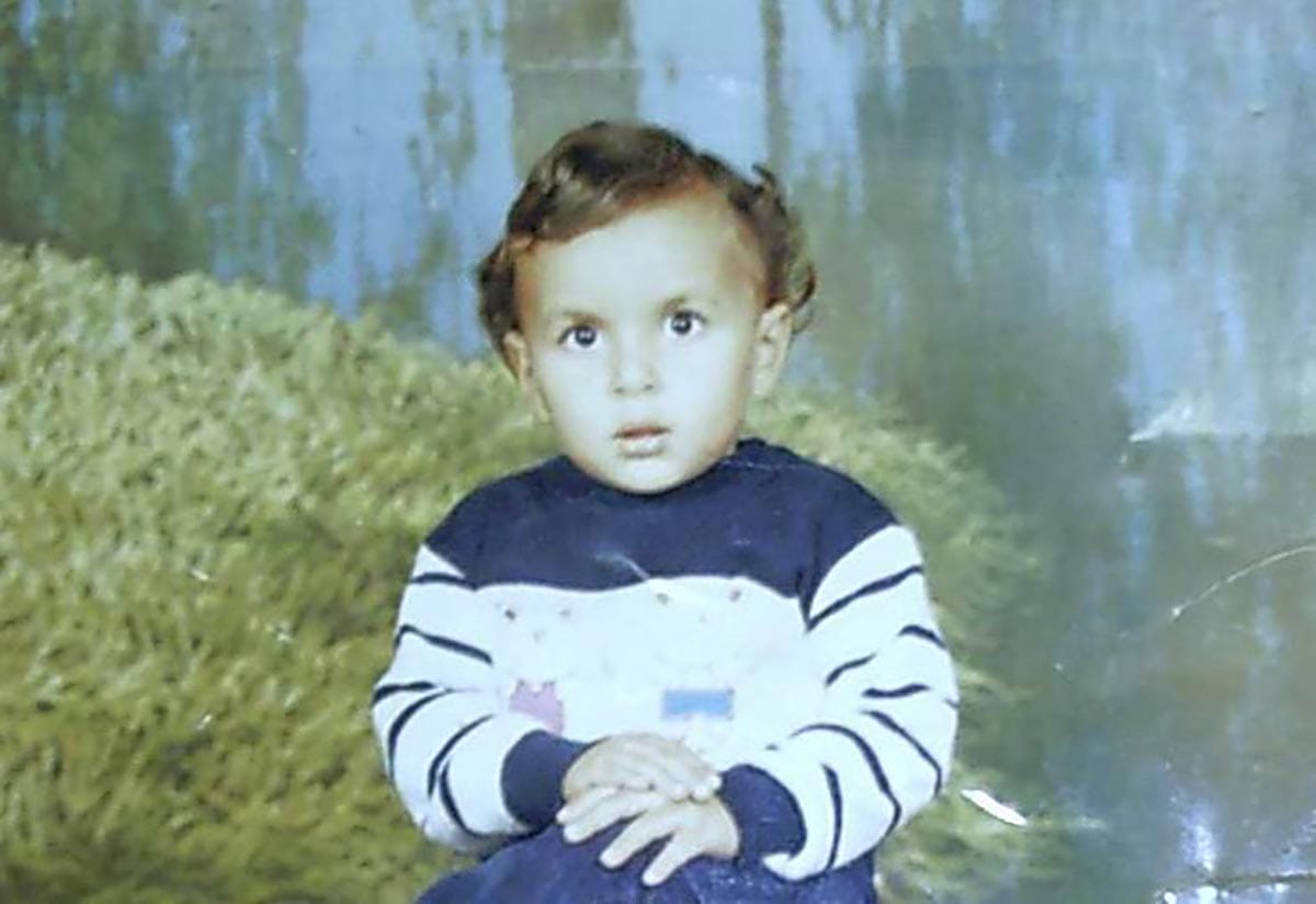 Mohamed Abou Donia at age 3, wearing a blue and white sweater.