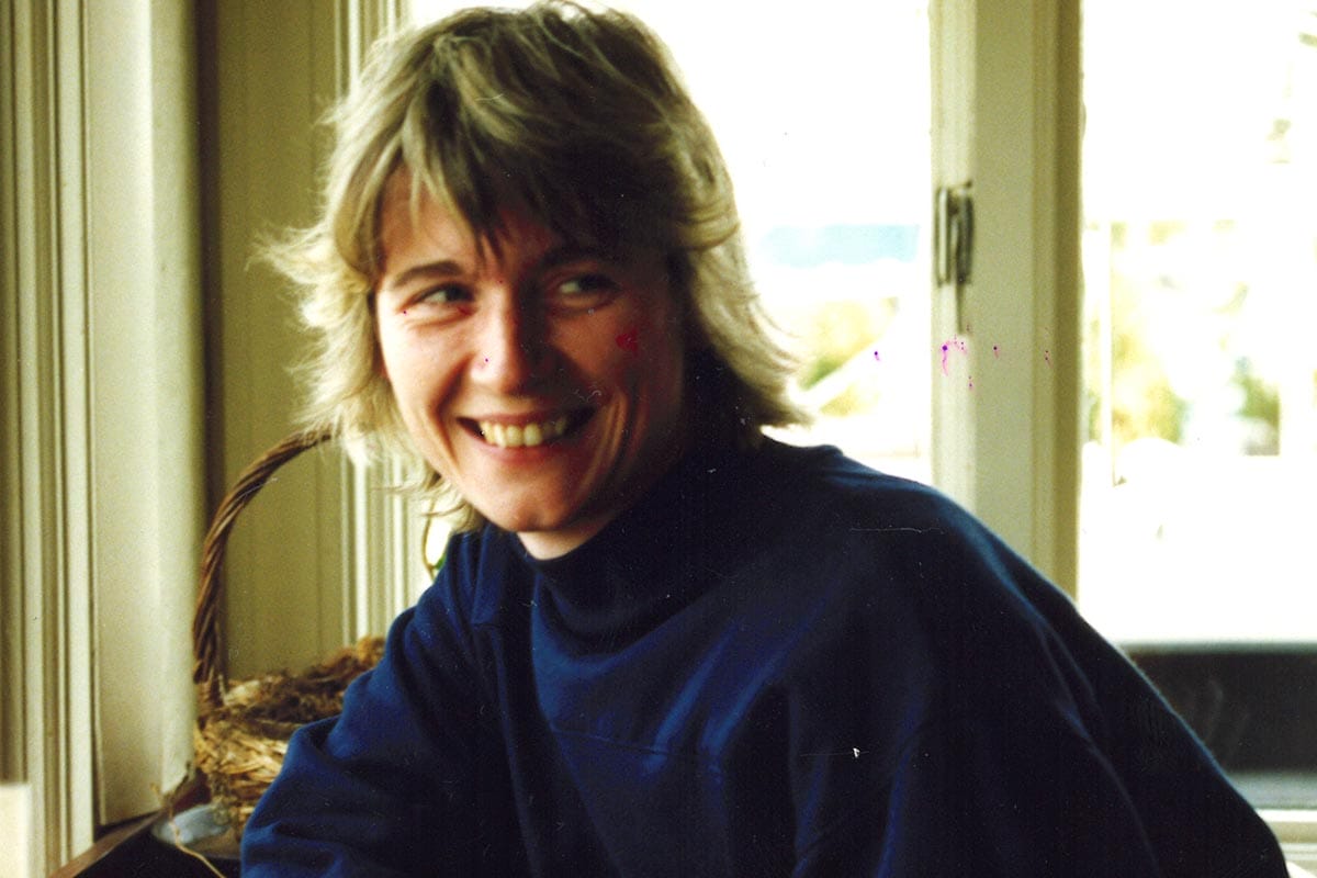 Ruth Lehmann, in a blue shirt, sitting in a light-filled room.