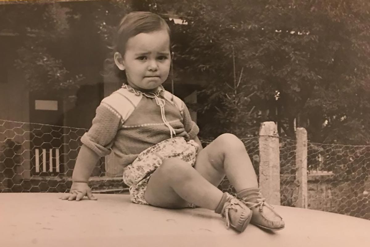 Silvi Rouskin, at age 2, sitting on top of a car.