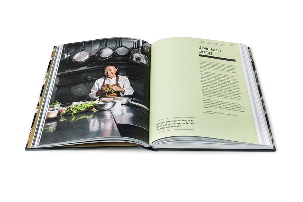 Interior view of A Place at the Table book featuring a photo of a chef in a kitchen