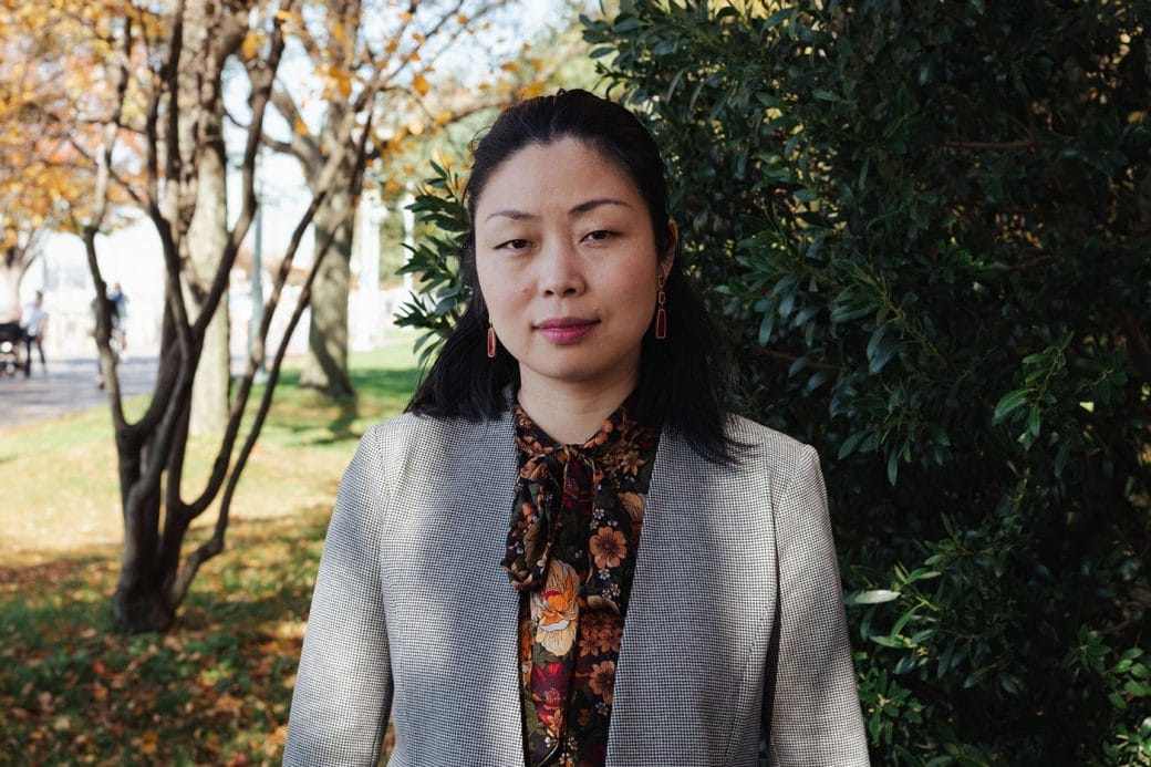 Nanfu Wang, in a floral white and gray jacket, in a New York City park.