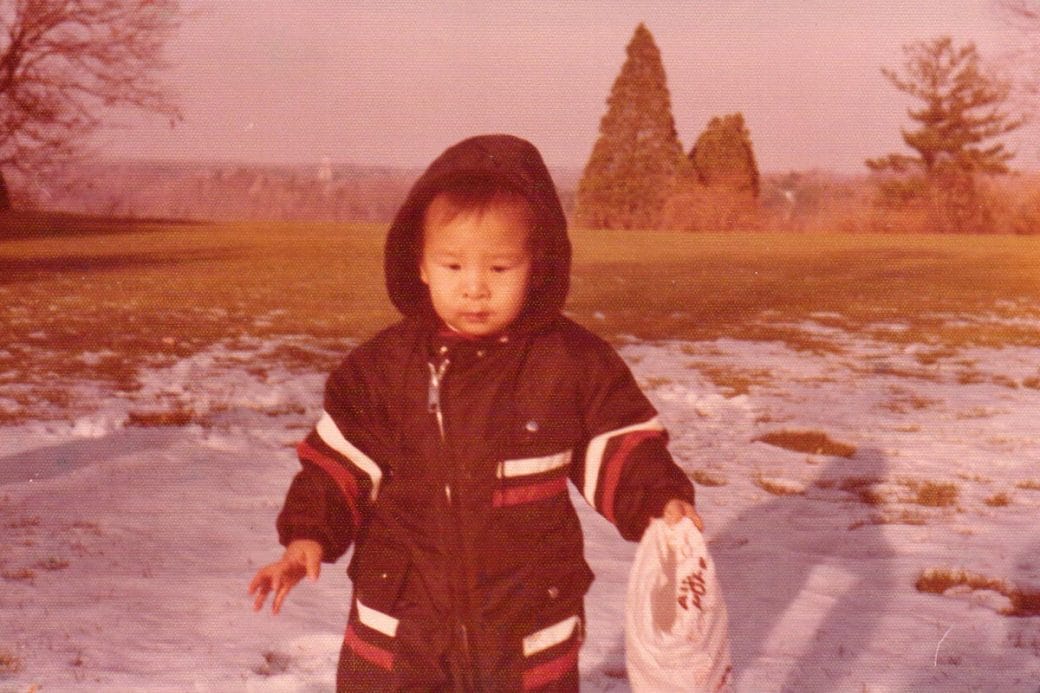 A photo of young Andrew Yang on a snowy hill.