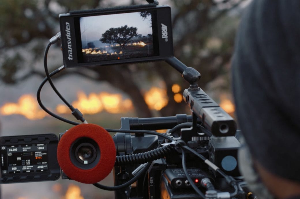A fire can be seen on the preview screen of a film camera.
