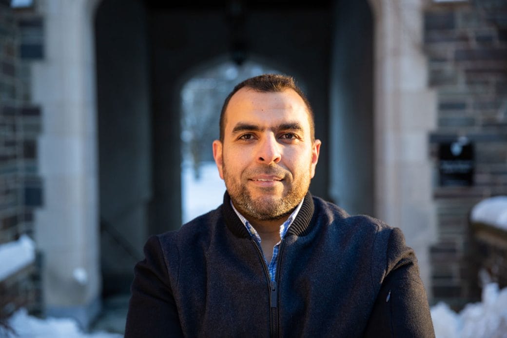 Mohamed Abou Donia framed by an archway of one of the Princeton University buildings.