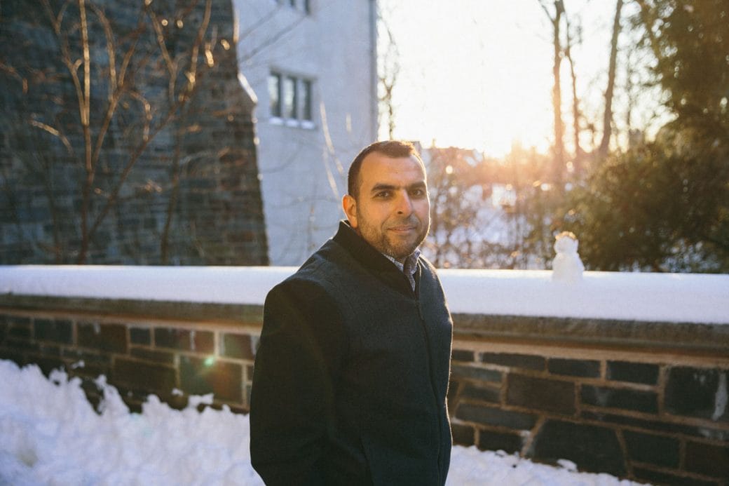Mohamed Abou Donia stands in front of a snow-covered Princeton University building.