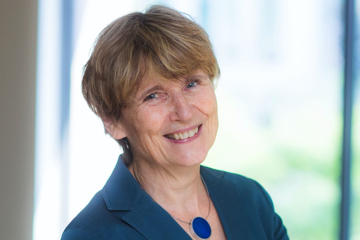 Ruth Lehmann smiling while wearing a blue blazer with a blue necklace.