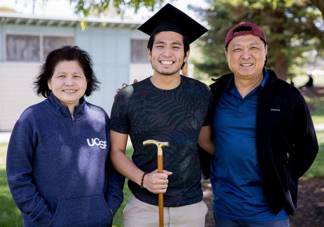 Jirayut “New” Latthivongskorn at his Medical School graduation with his parents.