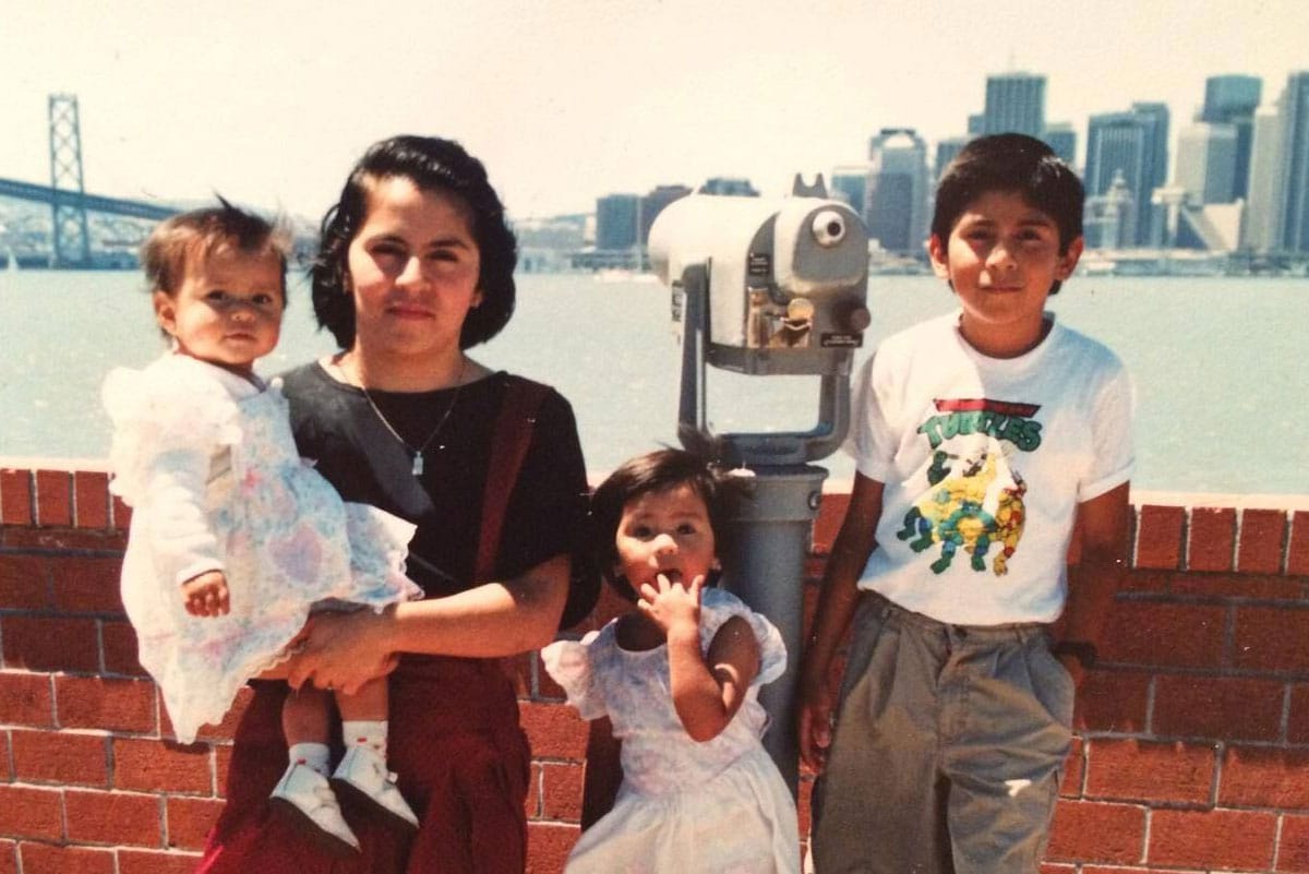 Denisse, her mother, and siblings with the skyline in the background.