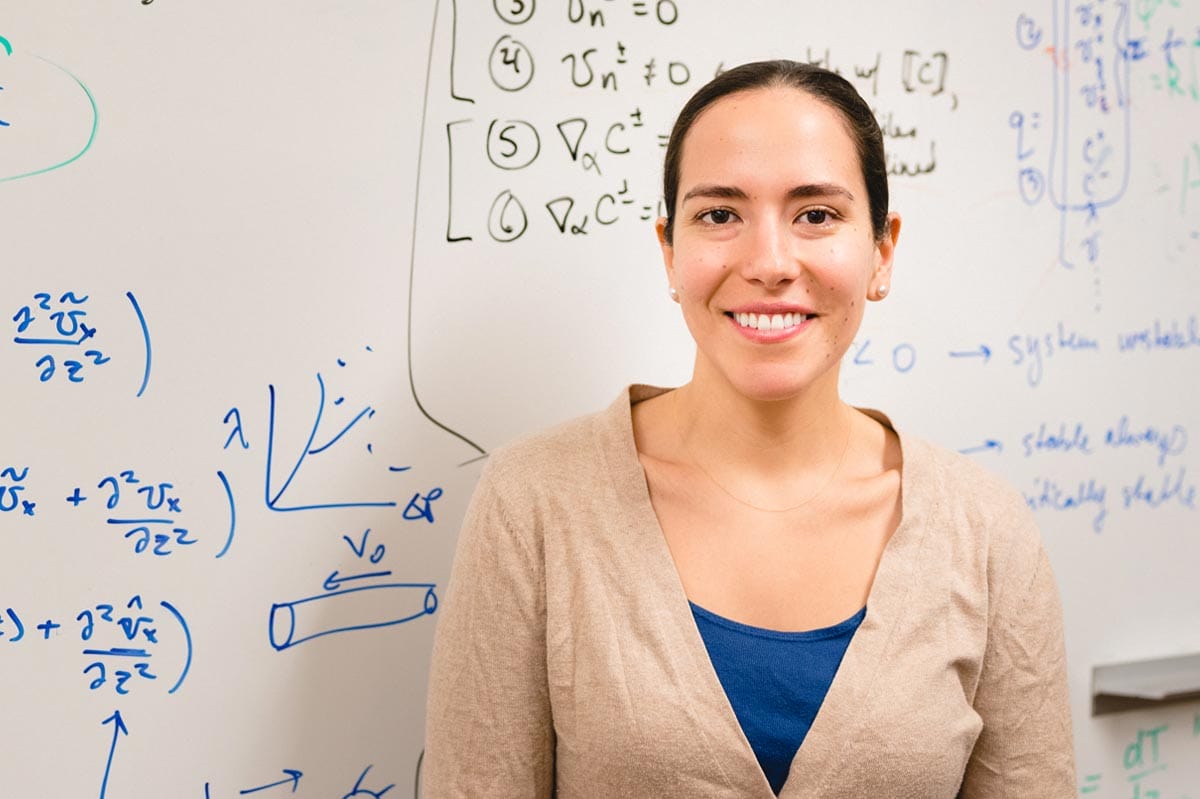 Markita Landry standing in front of a whiteboard with scientific equations.