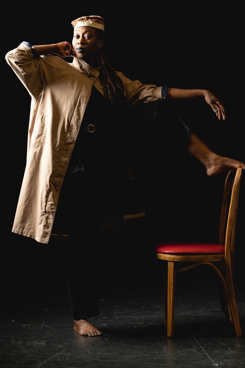 Tatiana Desardouin, foot raised and resting on a chair, looks into the camera.