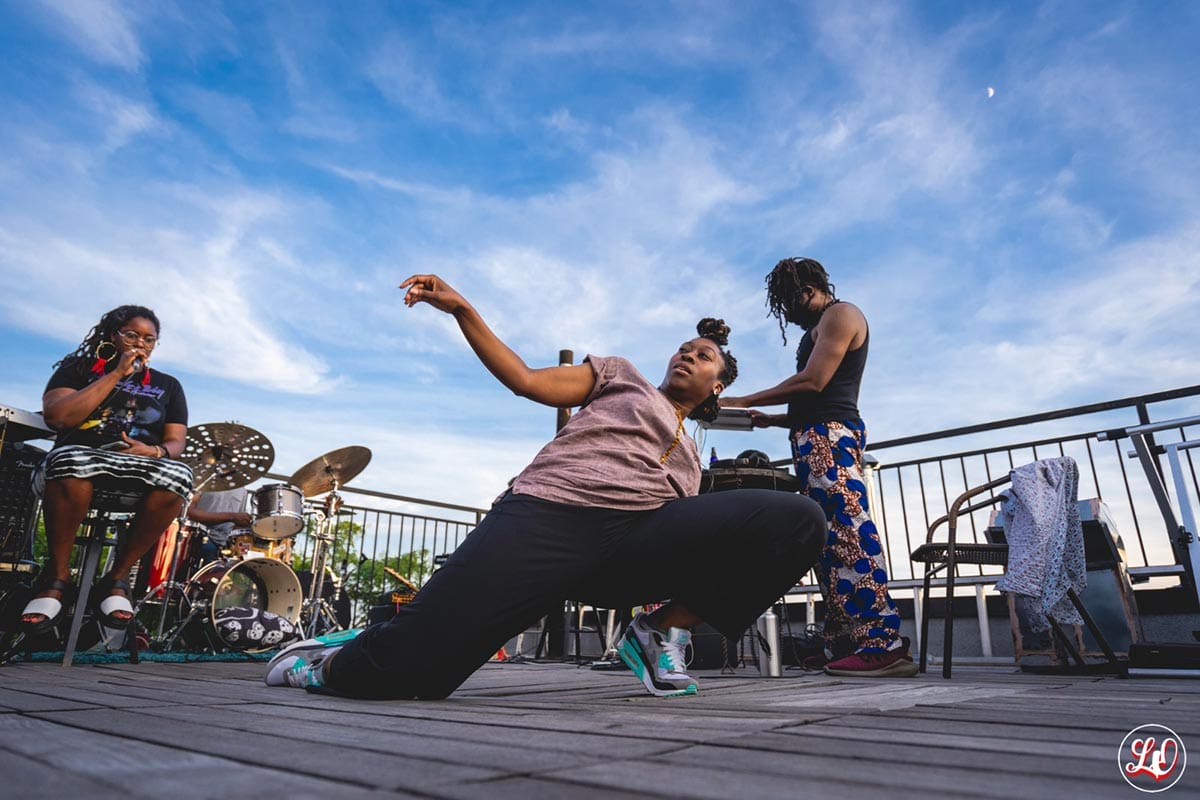 Photo of Tatiana Desardouin performing with musicians in the background